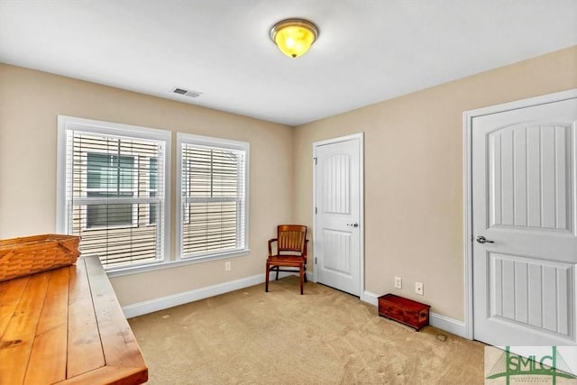 sitting room featuring light colored carpet