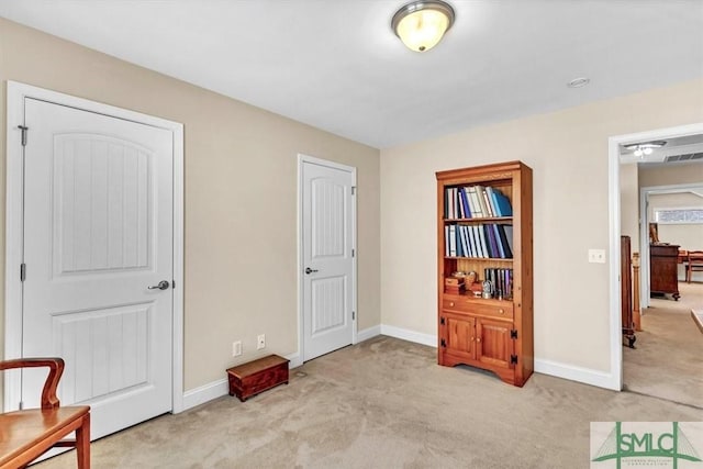 sitting room featuring light colored carpet