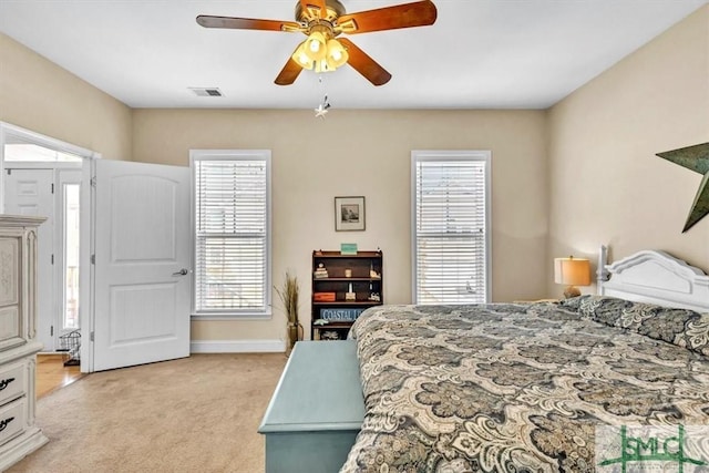 bedroom with light carpet and ceiling fan