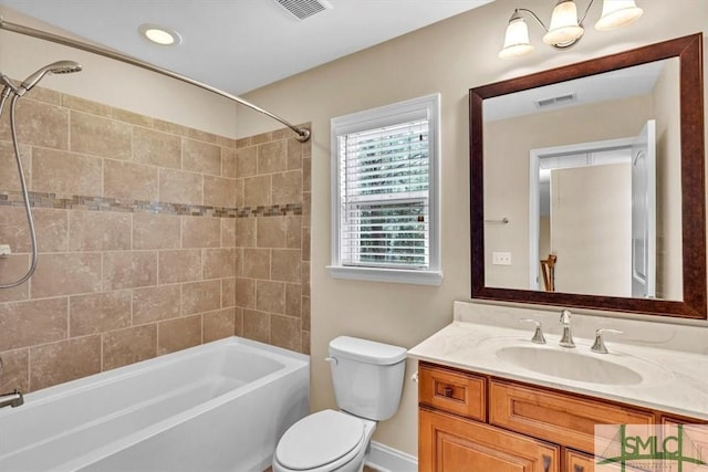 full bathroom with vanity, toilet, and tiled shower / bath combo