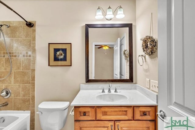 full bathroom with tiled shower / bath combo, vanity, and toilet