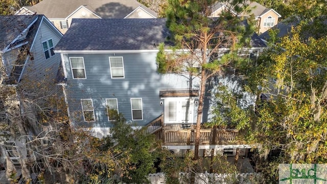 rear view of property with a wooden deck