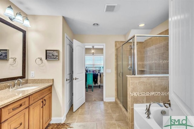 bathroom with vanity, tile patterned floors, and separate shower and tub