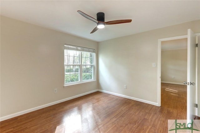 spare room featuring wood-type flooring and ceiling fan