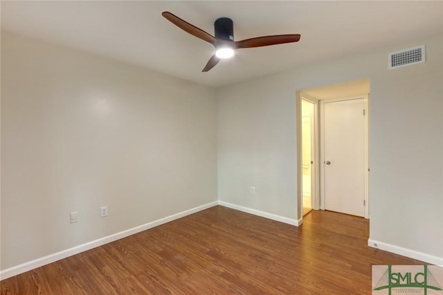 empty room with hardwood / wood-style floors and ceiling fan