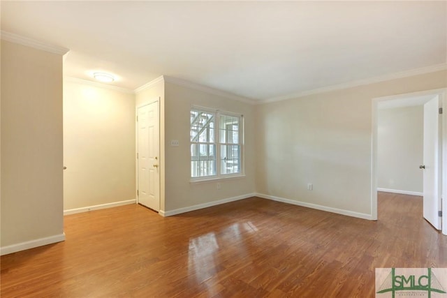 unfurnished room with hardwood / wood-style flooring and crown molding