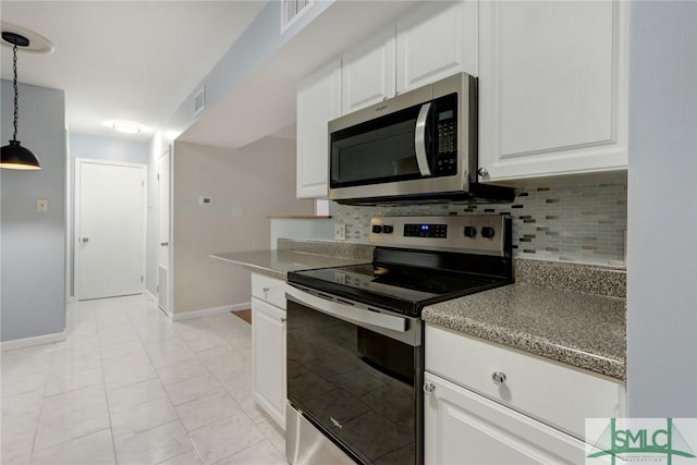 kitchen featuring tasteful backsplash, decorative light fixtures, light tile patterned floors, appliances with stainless steel finishes, and white cabinets