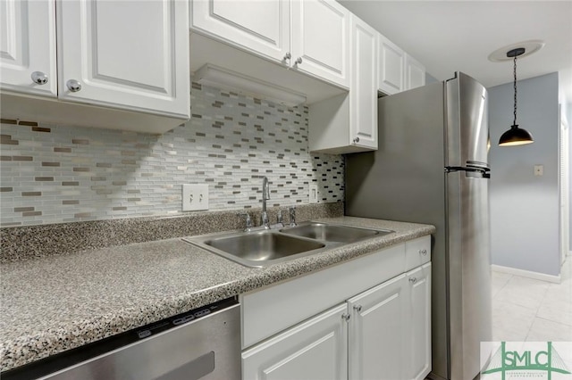 kitchen featuring stainless steel dishwasher, sink, and white cabinets