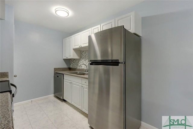 kitchen with white cabinetry, sink, tasteful backsplash, and stainless steel appliances