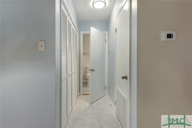 corridor with light tile patterned floors