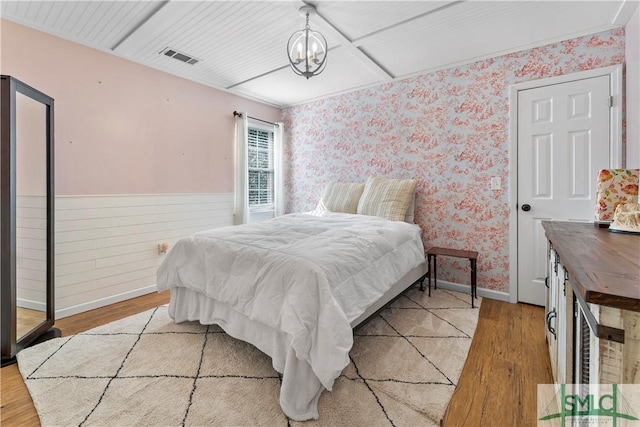 bedroom featuring a notable chandelier and light hardwood / wood-style flooring