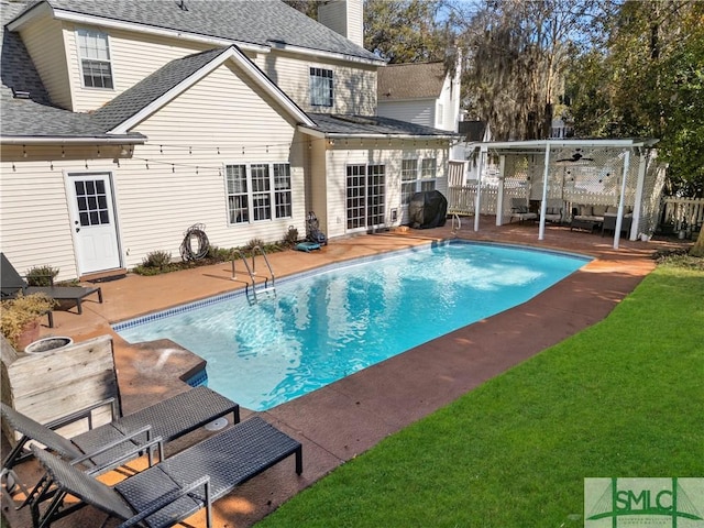 view of pool with a yard, grilling area, and a patio