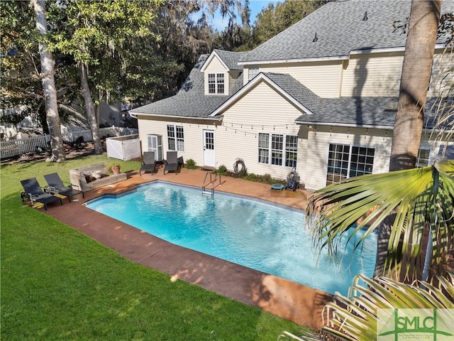 view of swimming pool with a yard and a patio area