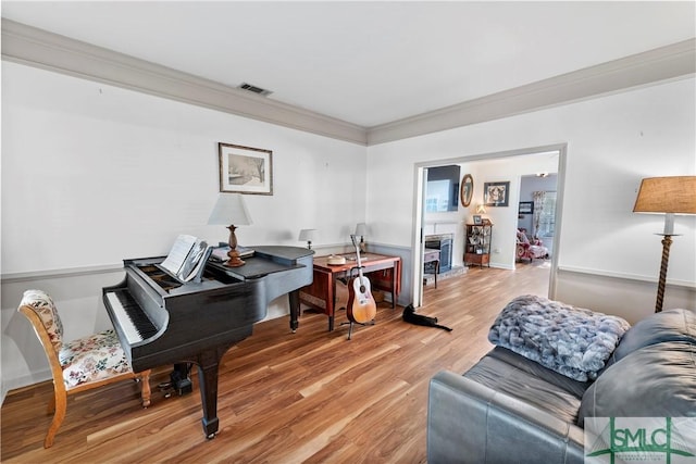 interior space featuring ornamental molding and wood-type flooring