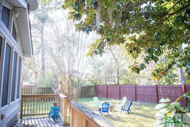 wooden terrace featuring a lawn