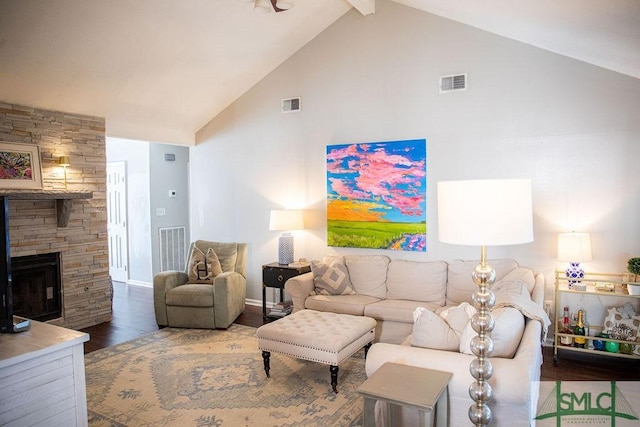 living room featuring hardwood / wood-style flooring, a fireplace, high vaulted ceiling, and beam ceiling