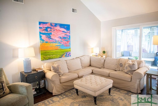 living room featuring high vaulted ceiling and hardwood / wood-style floors