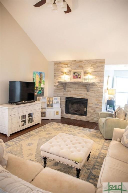 living room featuring wood-type flooring, high vaulted ceiling, ceiling fan, and a fireplace