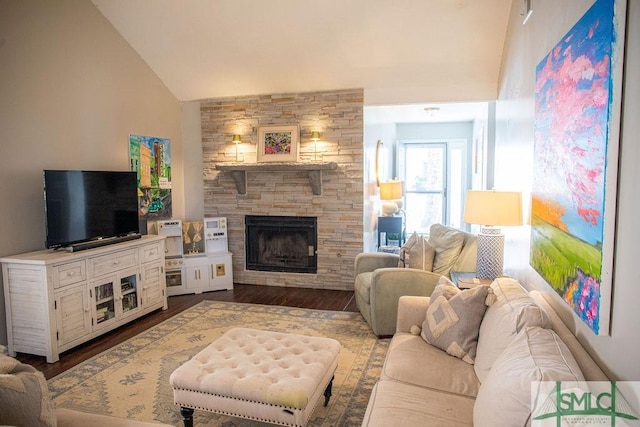 living room with hardwood / wood-style flooring, a fireplace, and high vaulted ceiling