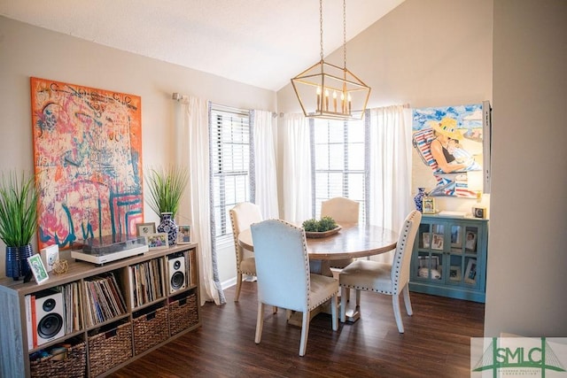 dining room featuring an inviting chandelier, lofted ceiling, and dark hardwood / wood-style floors