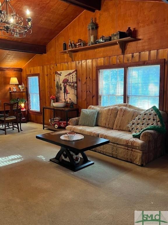 living room featuring light carpet, beam ceiling, wooden walls, and an inviting chandelier