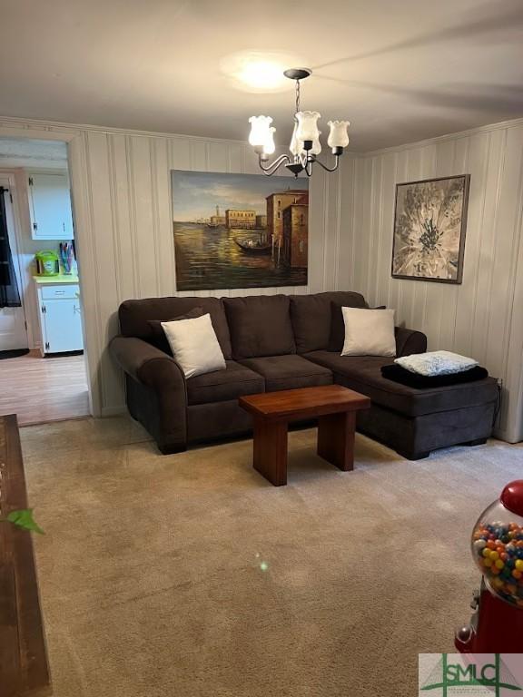 living room featuring light colored carpet and a chandelier