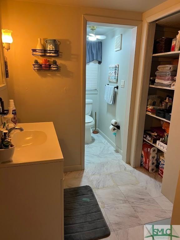 bathroom featuring vanity and toilet