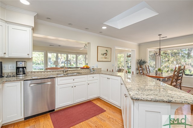 kitchen featuring sink, light wood-type flooring, dishwasher, kitchen peninsula, and white cabinets