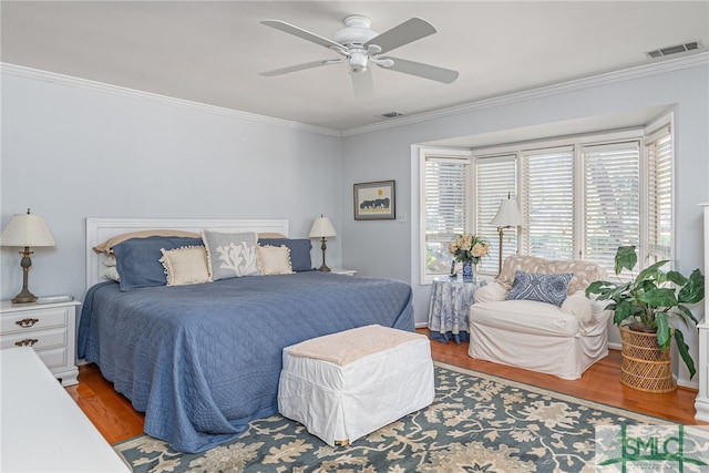 bedroom featuring crown molding, ceiling fan, and wood-type flooring