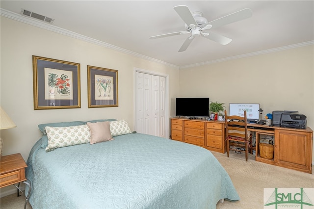 carpeted bedroom featuring crown molding, ceiling fan, and a closet