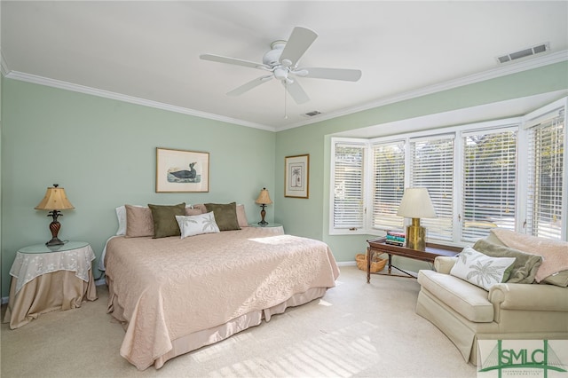 bedroom with ceiling fan, ornamental molding, and carpet floors