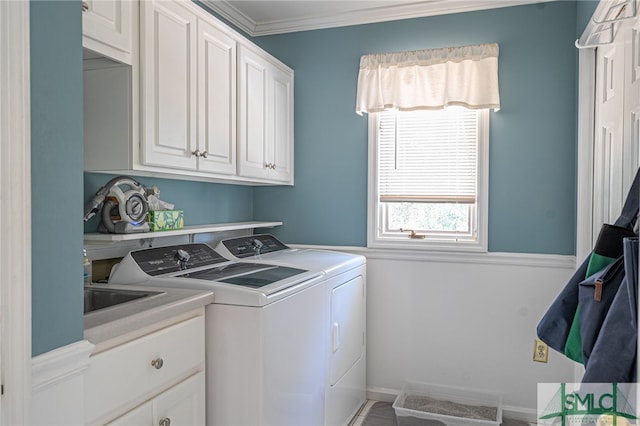 laundry area with crown molding, cabinets, and separate washer and dryer