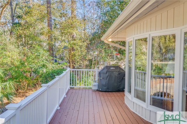 wooden terrace with a grill