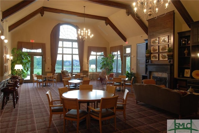 dining space with a premium fireplace, an inviting chandelier, beam ceiling, high vaulted ceiling, and dark colored carpet