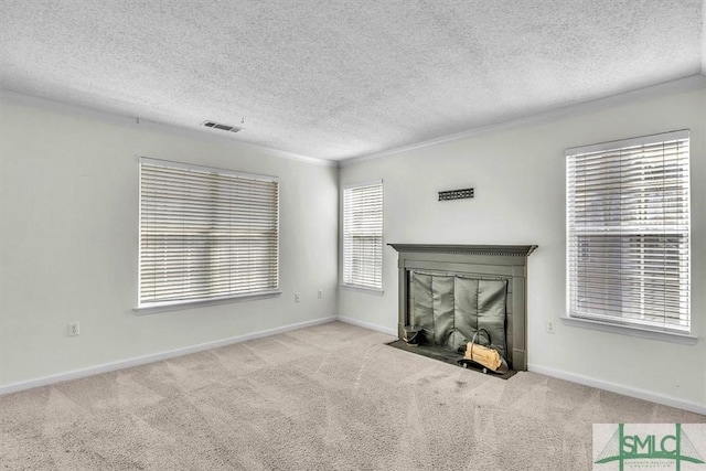 unfurnished living room featuring light carpet, a textured ceiling, and a fireplace