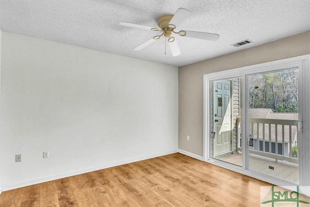 unfurnished room with a textured ceiling, light hardwood / wood-style flooring, and ceiling fan