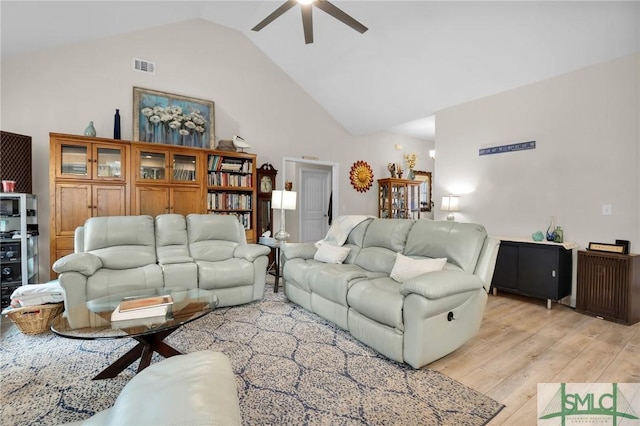 living room with ceiling fan, high vaulted ceiling, and light hardwood / wood-style floors