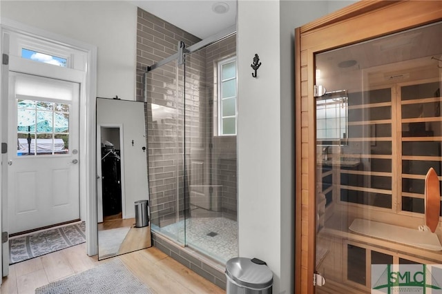 bathroom featuring hardwood / wood-style flooring and walk in shower