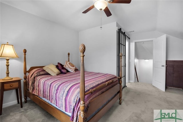 carpeted bedroom featuring ceiling fan, lofted ceiling, and a barn door