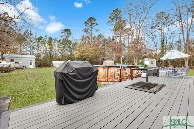 deck featuring a shed, grilling area, and a lawn