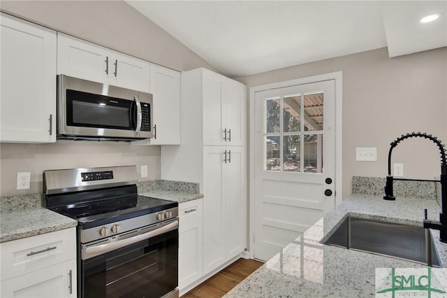 kitchen featuring appliances with stainless steel finishes, sink, and white cabinets