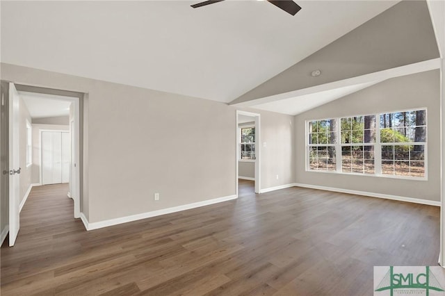 unfurnished living room featuring ceiling fan, dark hardwood / wood-style floors, and vaulted ceiling