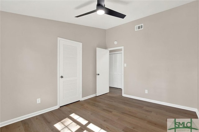 unfurnished bedroom with ceiling fan and wood-type flooring