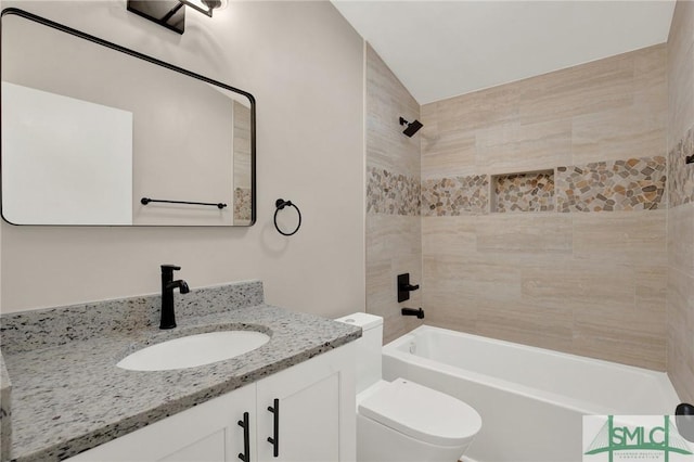 full bathroom with tiled shower / bath combo, vanity, and toilet