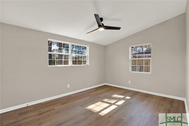 spare room with lofted ceiling, hardwood / wood-style flooring, and ceiling fan