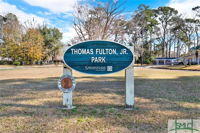 community sign featuring a lawn