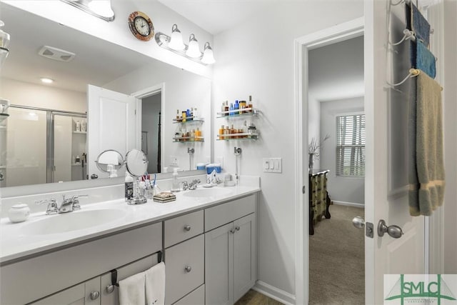 bathroom featuring vanity and a shower with door