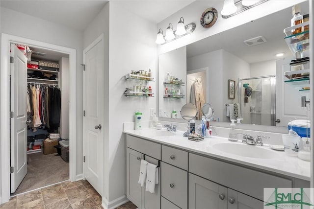 bathroom featuring vanity and a shower with door