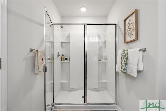 bathroom featuring a shower with door