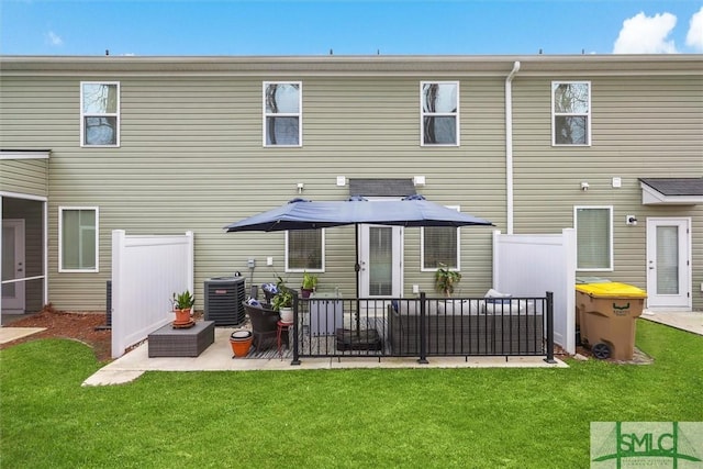 back of property featuring a patio, central AC unit, and a lawn